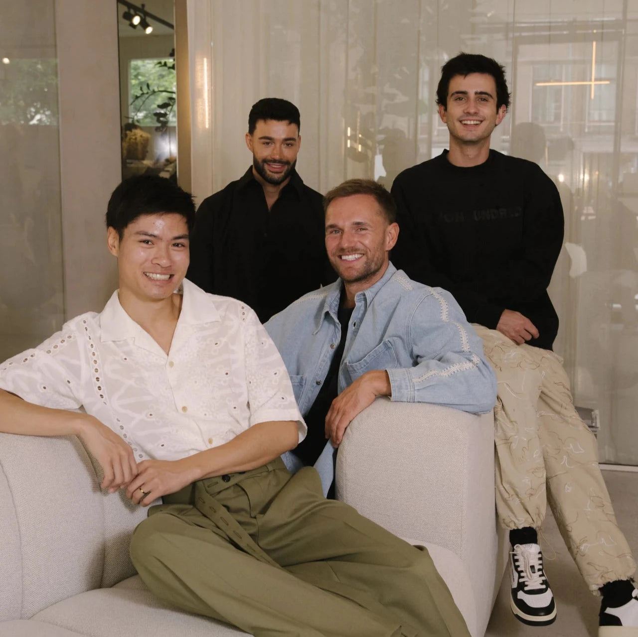 The Salon d’Homme team, a group of professional skincare experts, sitting together in the studio’s inviting lounge area